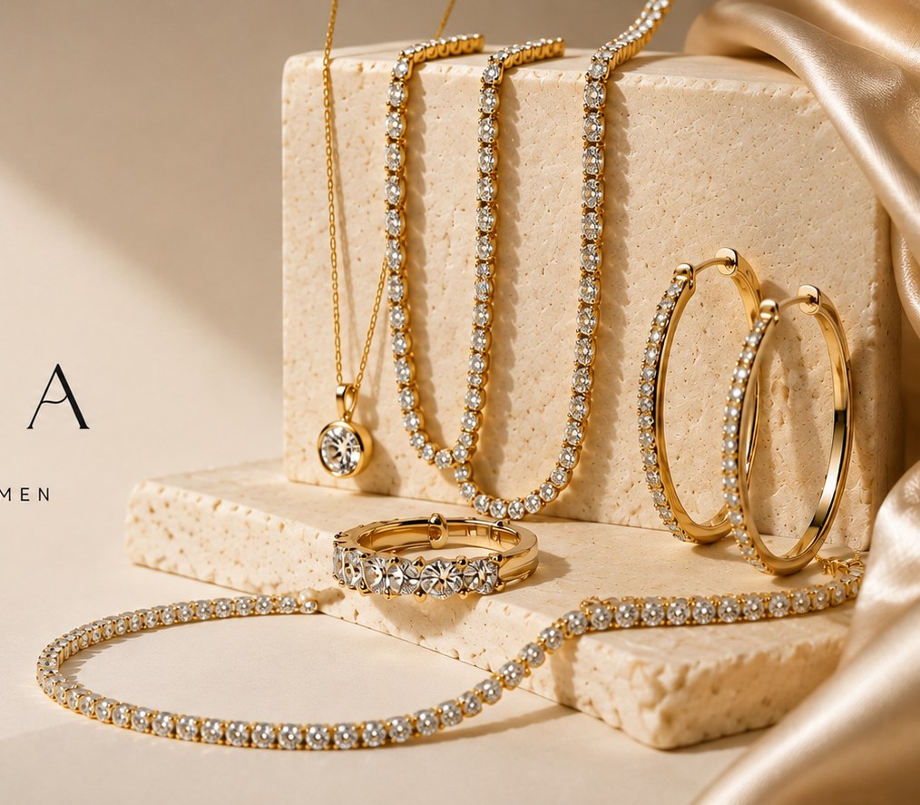LUMERA gold jewelry on travertine with champagne silk